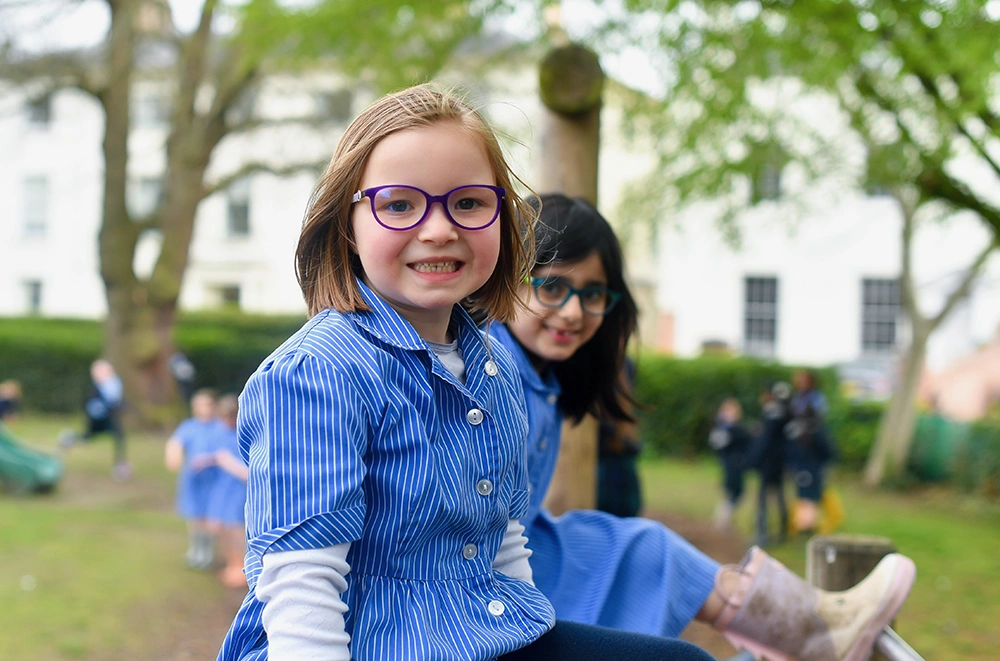 RGS Springfield pupils sitting on the play area outside