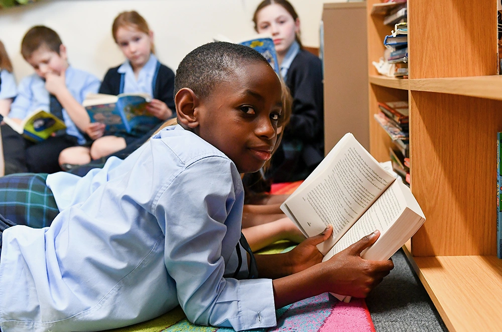 RGS Springfield pupil reading a book in the library