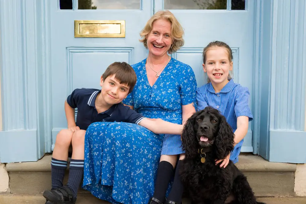 RGS Springfield Prep School Headmistress sat on steps with pupils and dog